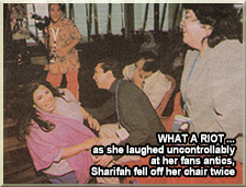 WHAT A RIOT ... as she laughed uncontrollably at her fans antics, Sharifah fell off her chair twice